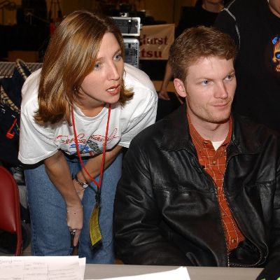 Kelley Earnhardt Miller and Dale Earnhardt Jr. are both looking at something that is not visible in the picture.